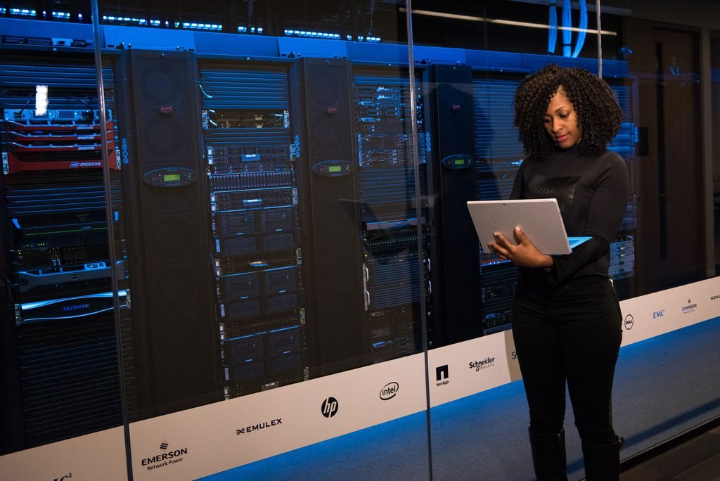 Engineer monitoring servers in a data center used for AI infrastructure