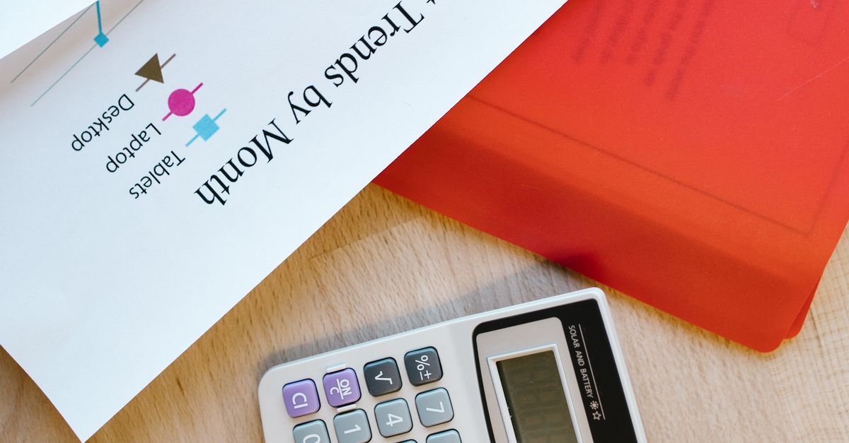 Calculator and generic business charts on a desk, illustrating financial records